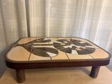 a coffee table with a mosaic design on top of it