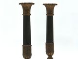 pair of antique bronze and black candlesticks on pedestals