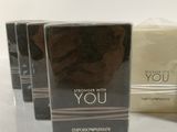 three boxes of perfume sitting on top of a white table