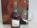 a bottle of liquor next to a glass of wine