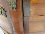 a wooden cabinet with brass hardware on it