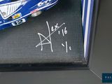 a toy car in a display case with writing on it