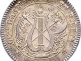 un gros plan d'une pièce de monnaie sur laquelle figure une harpe