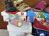 many pairs of shoes that are on top of boxes