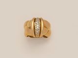 a yellow gold ring with a diamond set in the center