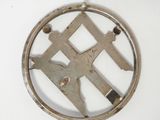 a metal object with a design on it on a white surface