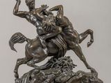 bronze statue of a man riding a horse with a woman on it