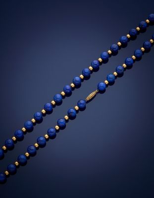 a gold and lapis beaded necklace with blue glass beads