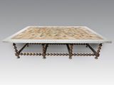 a marble top coffee table with turned legs