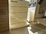 a room that has a lot of white furniture in it
