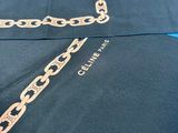 a gold chain on the back of a black shirt