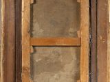 an old picture of a window with a wooden frame on the outside