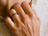 a woman with a ring on her neck and a ring on her hand