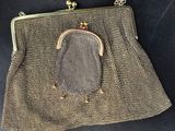 a close up of a purse on a black surface