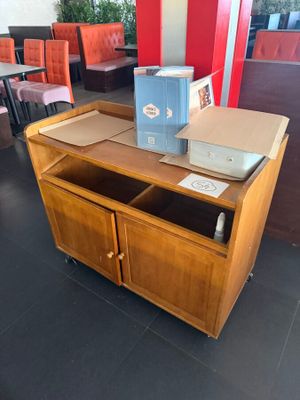 a table with a box on top of it in the middle of a room