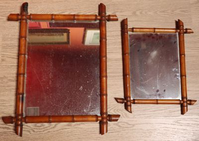 two mirrors sitting on a wooden table next to each other