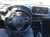 someone is sitting in the driver ' s seat of a car with their feet on the steering wheel