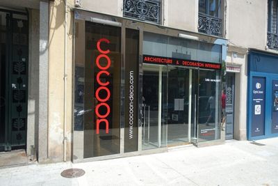 a red sign on the glass door of a building
