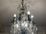 a crystal chandelier hanging from the ceiling in a room