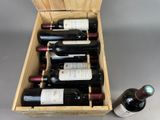 bottles of wine in a wooden box with a bottle of wine next to it