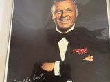 an old photo of a man in a tuxedo with a rose in his lapel