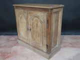 an old wooden cabinet with two doors and a drawer on top of it