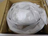 a white hat in a box wrapped in plastic