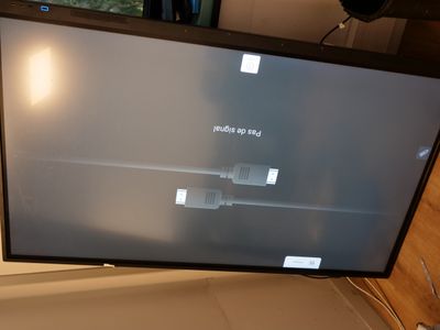 a flat screen tv sitting on top of a wooden table