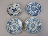 three blue and white plates with designs on them sitting on a table
