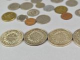 a lot of coins that are on the table