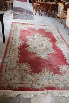 many chairs and tables in a room with a rug on the floor