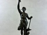 a bronze statue of a man holding a tree branch