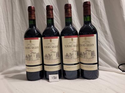 three bottles of red wine are lined up on a table
