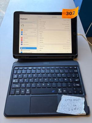 a tablet computer sitting on a table with a note on it