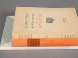 two books stacked on top of each other on a table