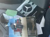 someone is sitting in the passenger seat of a car with a bunch of items on it
