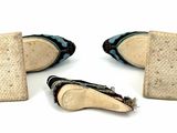two pairs of shoes that are sitting on a white surface