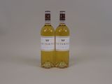 two bottles of white wine sitting next to each other on a table