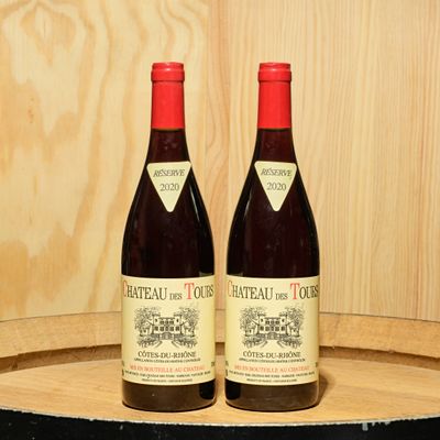 two bottles of wine sitting on top of a barrel