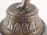 a silver vase with a bird on top of it