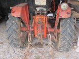 a tractor that is parked in a barn