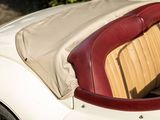 a white car with a red seat and a tan seat cover