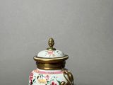 an image of a vase with a lid sitting on a table