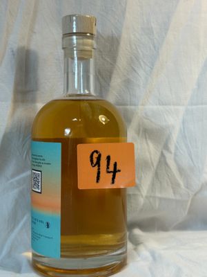 a bottle of alcohol sitting on a table with a price tag on it