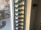 a wall mounted wine bottle rack in the corner of a room