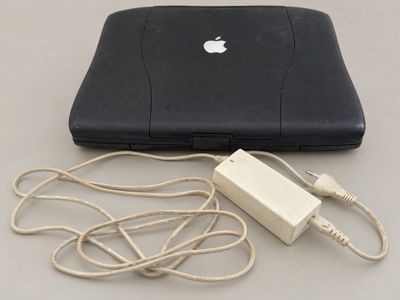 a laptop and a charger sitting on a table