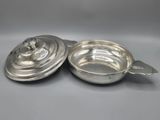 a pair of silverplated dishes with lids and handles