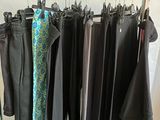 a lot of clothes hanging on a rack in a room