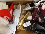 many pairs of shoes in a box with a price tag