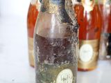 many bottles of liquid sitting on a table